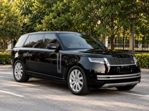 Black luxury SUV with a reflective windshield parked outdoors, illustrating windshield solar control film.
