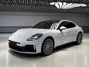 White luxury sedan with a clear windshield in a modern showroom, illustrating exterior windshield protection film.