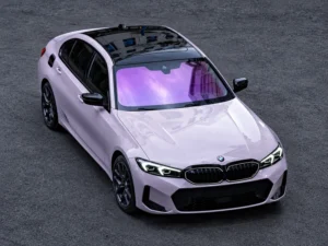Pale lavender sedan with a violet-tinted windshield on a city street, illustrating violet-hue windshield protection film.